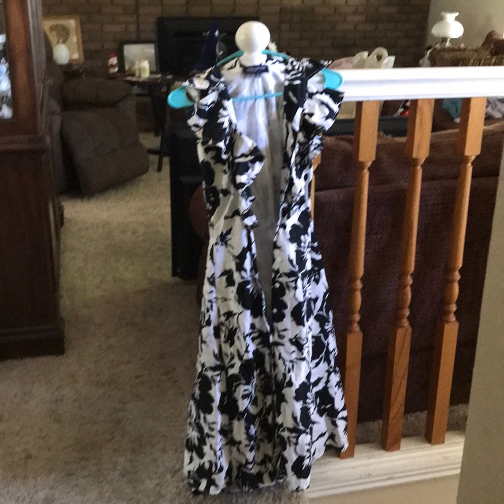 Ruffled neck, button up front, includes tie